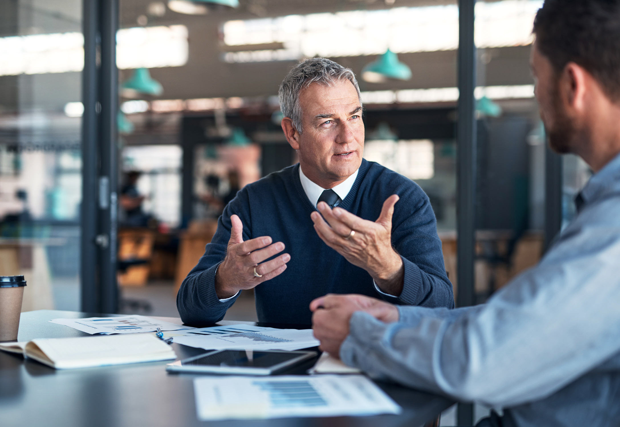 Two business professionals speaking at a conference table.