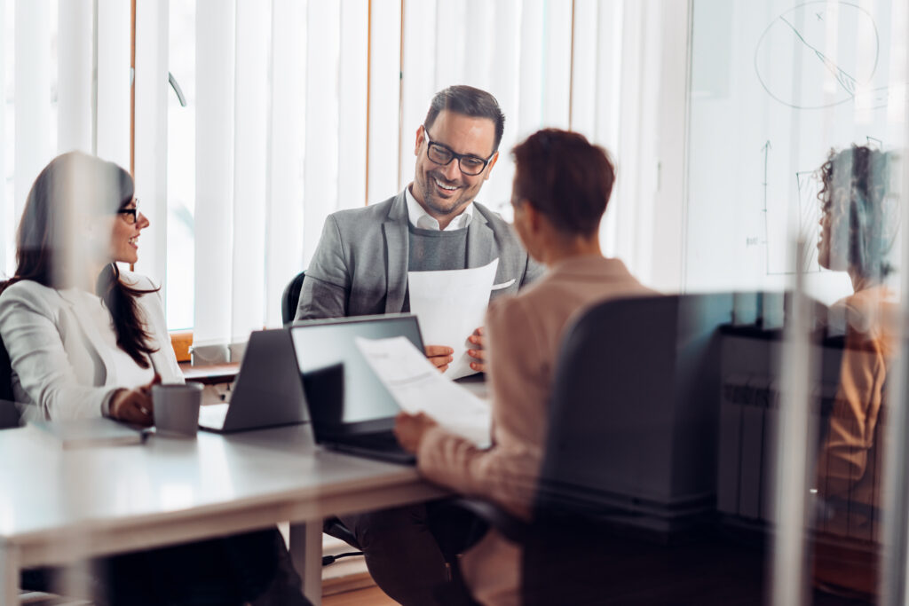 Business professionals meeting together in a conference room.